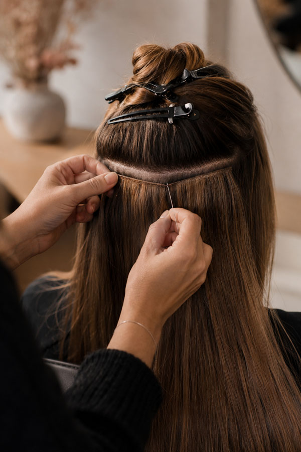 Hair being washed and prepared at the start of an extension appointment